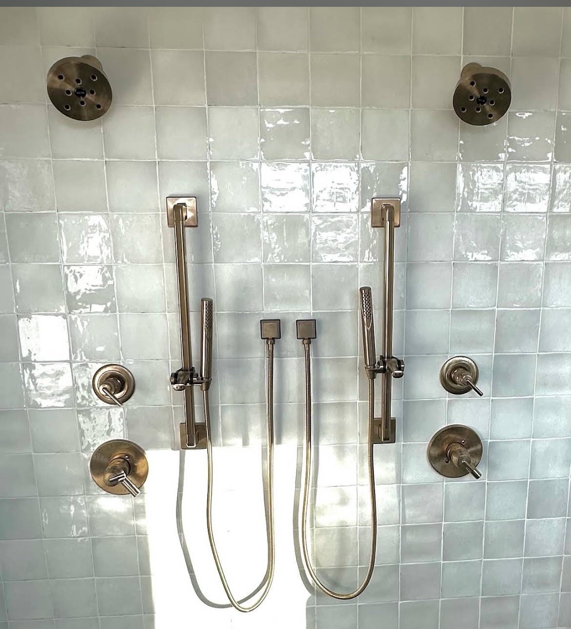 Dual-head tiled shower with brushed brass fixtures